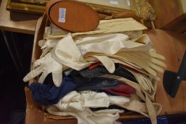 A box full of vintage and antique gloves, various colours and eras.