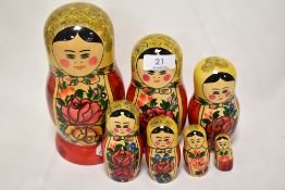A set of seven Mid Century Russian 'USSR' folk art matrioska dolls hand painted in a traditional