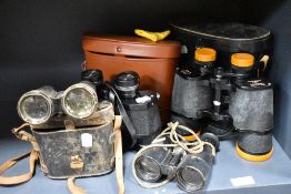Four pairs of binoculars including Taylor Hobson x6, Bell and Howell 8x 40 and Tecnar 12 x 50.