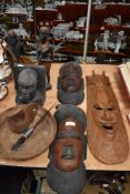 Three African tribal wall masks with a pair of Massai warrior figures and an Ebony book end.