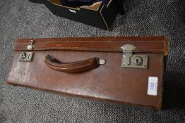 An early 20th century leather bound travel trunk or suitcase.