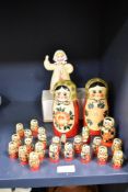 A set of two expanding Mid Century Russian 'USSR' folk art matrioska dolls hand painted in a