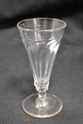 An antique ale glass having fluted bowl with writhen form twist on circular spread foot.