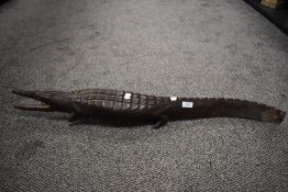 An Ethnic wood carved study of a caiman crocodile 90cm long. some damage to feet.