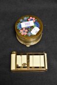 Two mid century musical make up compacts, one in the form of a camera Swiss made and a similar