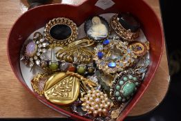 A selection of costume jewellery including Opal style brooch, pendants and enamel pin badges