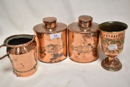 A pair of 19th century copper tea caddies having an impressed design with two other copper items.