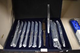 A cased set of Suissine steak knives.