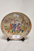 An 18th century Chinese porcelain saucer, hand decorated in famille vert with scene of goods being
