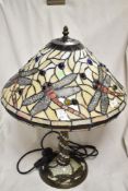 A modern Tiffany styled leaded light lamp, having a dragon fly shade design and base.