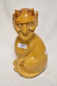 A studio pottery study of mythical cat / devil creature having mustard yellow glaze, in a Brannam