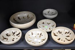 A set of six matching studio pottery bowls having natural glazes.