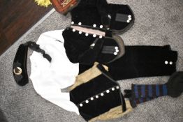 A selection of vintage textiles including a paige boy outfit.