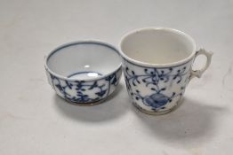An antique porcelain tea cup in a Miessen style with a similar tea bowl.