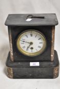 A Victorian slate and red marble mantel clock with key.