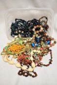 A collection of vintage costume jewellery including necklaces, beads and bangles.