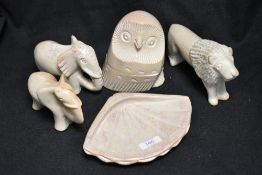 A selection of vintage soap stone carved animal studies including two elephants an owl and a shell