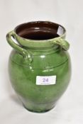 An Arts and Crafts period studio pottery vase in an olive green lustre glaze with three sweeping