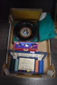 A selection of vintage gambling and roulette items including card shuffler and tokens.