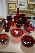 A selection of ruby and cranberry glass wares including trinket dishes, glasses and vase.