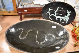 Two mid century studio pottery oval platters having abstract designs.
