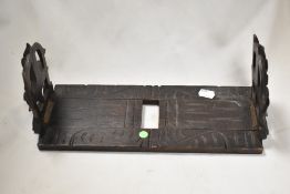 An early 20th century folding book shelf having a carved Black Forrest style design.