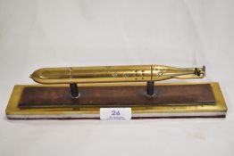 A fine desk top paper weight or replica model of a military Naval torpedo. Machined in brass and