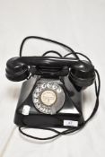 An early 20th century GPO Bakelite telephone set.