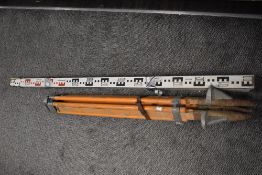A Hilger Watts Halden surveyors levelling instrument with tripod stand and measure stick.