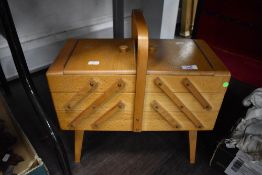 A 1960's fold out sewing case in beech wood.