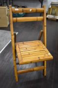 A fold out Bamboo chair in the campaign style.