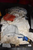 A miscellany of vintage items and accessories, including evening scarves, children's wear, apron and