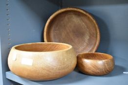 Three vintage Teak or similar turned wood bowls largest measures 25cm wide.