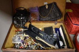 A vintage leather case full of costume jewellery and trinkets.