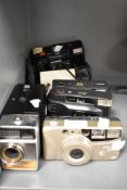 Four vintage photographic cameras including Olympus and Fuji also a Halinamatic super 8mm camera.