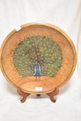 A vintage Cherry wood bowl decorated with a Peacock design, signed Wilkinson. 37cm wide.
