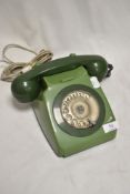 A vintge GPO telephone set in olive green.