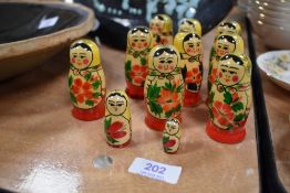 A set of nine vintage Russian 'USSR' Matrioshka dolls hand painted in traditional designs, each doll
