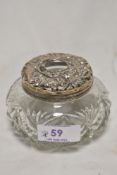 A white metal topped cut-glass hair tidy, lacking marks and denting and wear throughout.