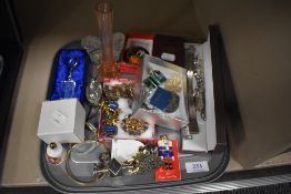 A tray of mixed costume jewellery including white metal bracelets, a Russian badge and glass items.