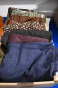 A box of traditional and retro fabric, including needle cord and vintage flecked wool in navy blue.