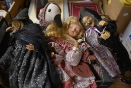 Four porcelain headed dolls including two Witch dolls and a duck doorstop.
