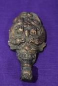 A Chinese Ruyi Scepter or buckle fastener in the form of a central dragon form hook surrounded by