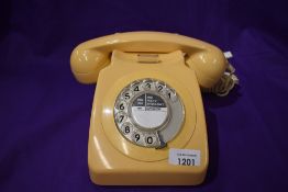 A vintage GPO telephone set in a light peach colour.