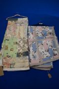Two retro quilts, one padded having neutral floral pattern and pink and blue sections.