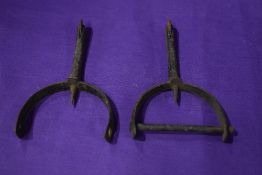 A pair of antique boot spurs for horse riding.