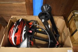 A selection of cycling items including a helmet, bike stand, two bicycle locks and a pump.
