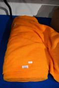 A bolt of mid century orange and yellow fabric.