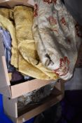 Two boxes of vintage and traditional fabrics, including upholstery and lining fabric.