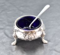 A Victorian silver salt, of circular form with embossed foliate decoration Bristol blue glass